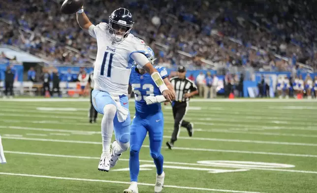 Tennessee Titans quarterback Mason Rudolph (11) runs into the end zone for a touchdown during the first half of an NFL football game against the Detroit Lions, Sunday, Oct. 27, 2024, in Detroit. (AP Photo/Carlos Osorio)