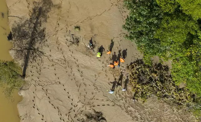 Search crews look for victims in the aftermath of Hurricane Helene, Tuesday, Oct. 1, 2024, in Swannanoa, N.C. (AP Photo/Mike Stewart)