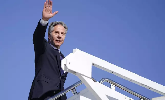 Secretary of State Antony Blinken waves as he boards a plane en route to the Middle East as he departs Joint Base Andrews, Md., Monday, Oct. 21, 2024. (Nathan Howard/Pool Photo via AP)