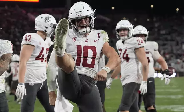 Washington State quarterback John Mateer (10) celebrates a touchdown during the second half of an NCAA college football game against San Diego State Saturday, Oct. 26, 2024, in San Diego. (AP Photo/Gregory Bull)