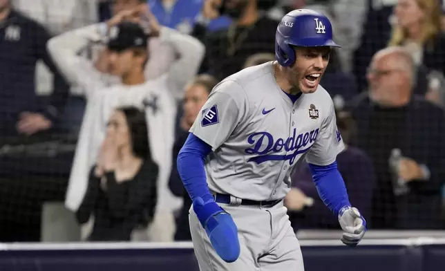 Los Angeles Dodgers' Freddie Freeman celebrates after scoring on a double by Teoscar Hernández during the fifth inning in Game 5 of the baseball World Series, Wednesday, Oct. 30, 2024, in New York. (AP Photo/Ashley Landis)