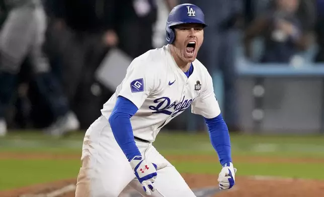 Los Angeles Dodgers' Freddie Freeman celebrates after hitting a walk-off grand slam home run during the 10th inning in Game 1 of the baseball World Series against the New York Yankees, Friday, Oct. 25, 2024, in Los Angeles. (AP Photo/Mark J. Terrill)