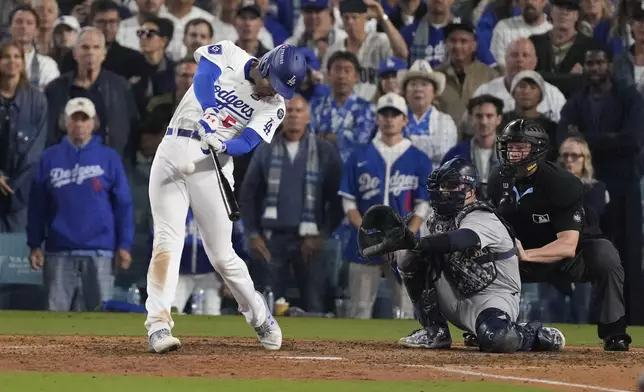 Los Angeles Dodgers' Freddie Freeman connects for a walk-off grand slam home run during the 10th inning in Game 1 of the baseball World Series against the New York Yankees, Friday, Oct. 25, 2024, in Los Angeles. (AP Photo/Mark J. Terrill)