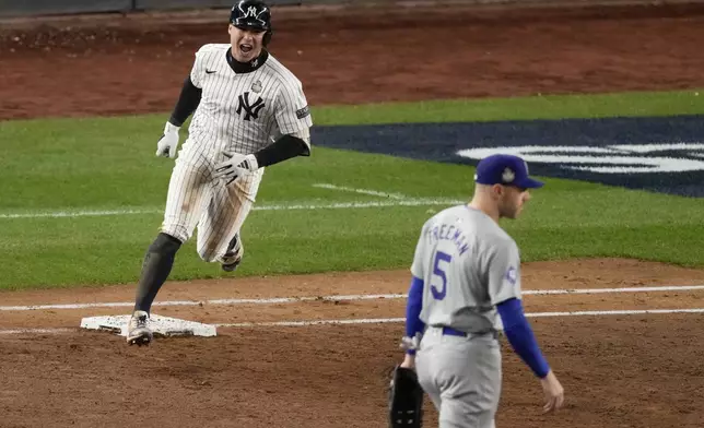 New York Yankees' Anthony Volpe celebrates his grand slam home run against the Los Angeles Dodgers during the third inning in Game 4 of the baseball World Series, Tuesday, Oct. 29, 2024, in New York. (AP Photo/Frank Franklin II)