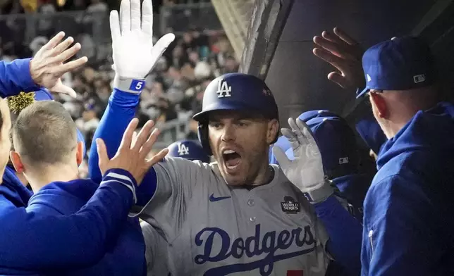 Los Angeles Dodgers' Freddie Freeman celebrates his two-run home run against the New York Yankees during the first inning in Game 3 of the baseball World Series, Monday, Oct. 28, 2024, in New York. (AP Photo/Ashley Landis)