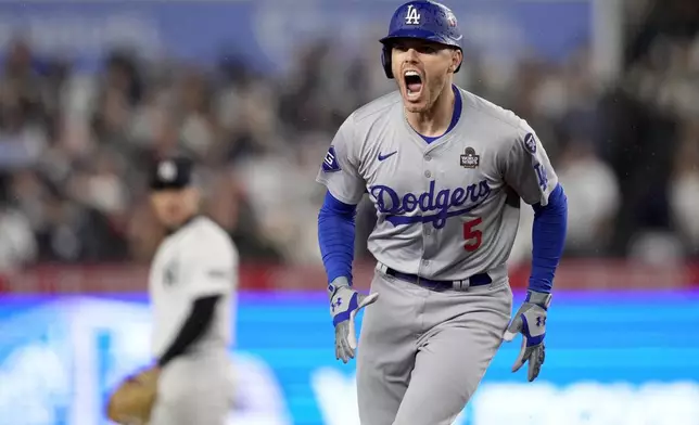 Los Angeles Dodgers' Freddie Freeman celebrates his two-run home run against the New York Yankees during the first inning in Game 4 of the baseball World Series, Tuesday, Oct. 29, 2024, in New York. (AP Photo/Ashley Landis)