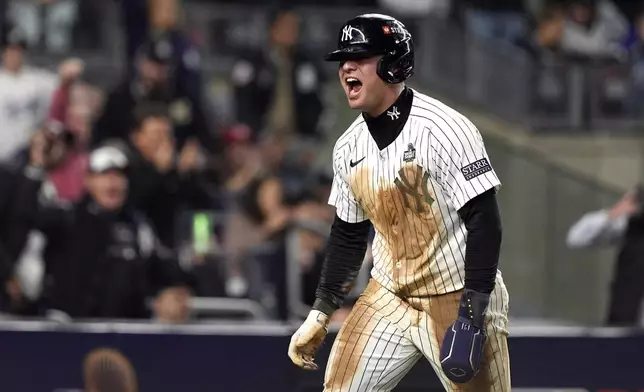 New York Yankees' Anthony Volpe reacts after scoring against the Los Angeles Dodgers during the eighth inning in Game 4 of the baseball World Series, Tuesday, Oct. 29, 2024, in New York. (AP Photo/Godofredo A. Vásquez)