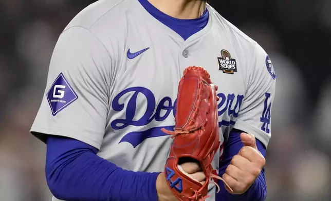 Los Angeles Dodgers pitcher Anthony Banda celebrates the end of the seventh inning in Game 3 of the baseball World Series against the New York Yankees, Monday, Oct. 28, 2024, in New York. (AP Photo/Ashley Landis)