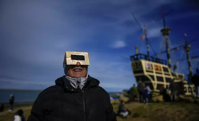 People watch an annular solar eclipse in Puerto San Julian, Argentina, Wednesday, Oct. 2, 2024. (AP Photo/Natacha Pisarenko)