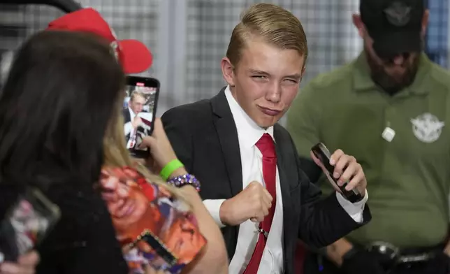 A young supporter arrives before Republican presidential nominee former President Donald Trump at a campaign event at Dane Manufacturing, Tuesday, Oct. 1, 2024, in Waunakee, Wis. (AP Photo/Charlie Neibergall)