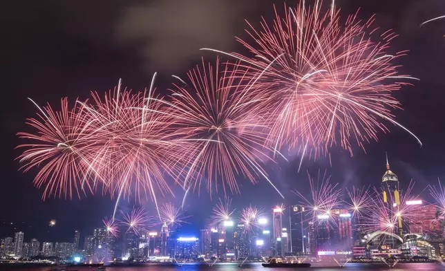 Fireworks explode over Victoria Harbour to mark the 75th National Day of the People's Republic of China, at Tsim Sha Tsui in Hong Kong, Tuesday, Oct. 1, 2024. (AP Photo/Chan Long Hei)