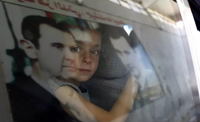 A Syrian girl fleeing the war in Lebanon with family, arrives at the Syrian-Lebanese border crossing in Jousieh, Syria, Tuesday, Oct. 2, 2024. (AP Photo/Omar Sanadiki)