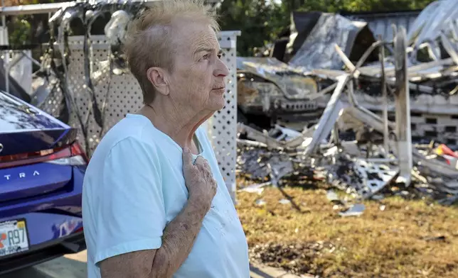 Georgia Marcum speaks about her neighbor Patricia Mikos who died when her house caught fire during Hurricane Helene Wednesday, Oct. 2, 2024, in Dunedin, Fla. (AP Photo/Mike Carlson)