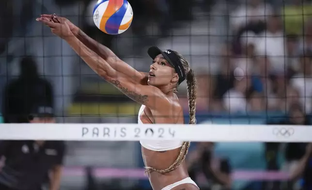 FILE - Canada's Brandie Wilkerson returns thea ball in the women's beach volleyball gold medal match between Brazil and Canada, at the 2024 Summer Olympics, Aug. 9, 2024, in Paris, France. (AP Photo/Louise Delmotte, File)