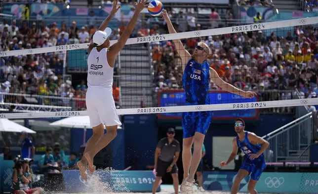 FILE - United States' Chase Budinger, center right, shoots against Spain's Pablo Herrera Allepuz, left, in a beach volleyball match at the 2024 Summer Olympics, Aug. 2, 2024, in Paris, France. (AP Photo/Robert F. Bukaty, File)