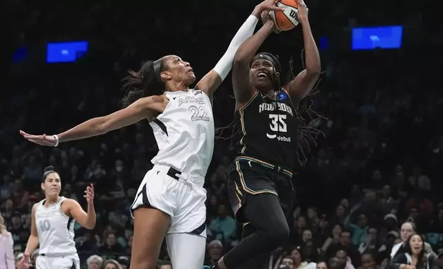 Las Vegas Aces' A'ja Wilson (22) defends a shot by New York Liberty's Jonquel Jones (35) during the first half of a WNBA basketball semifinal game, Tuesday, Oct. 1, 2024, in New York. (AP Photo/Frank Franklin II)