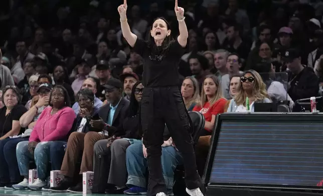 New York Liberty head coach Sandy Brondello calls out to her team during the first half of a WNBA basketball semifinal game against the Las Vegas Aces, Tuesday, Oct. 1, 2024, in New York. (AP Photo/Frank Franklin II)