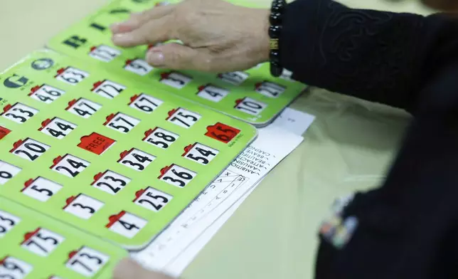 A woman plays Bingo at Sunshine Adult Day Center in Bergenfield, N.J., Monday, Aug. 26, 2024. (AP Photo/Kena Betancur)