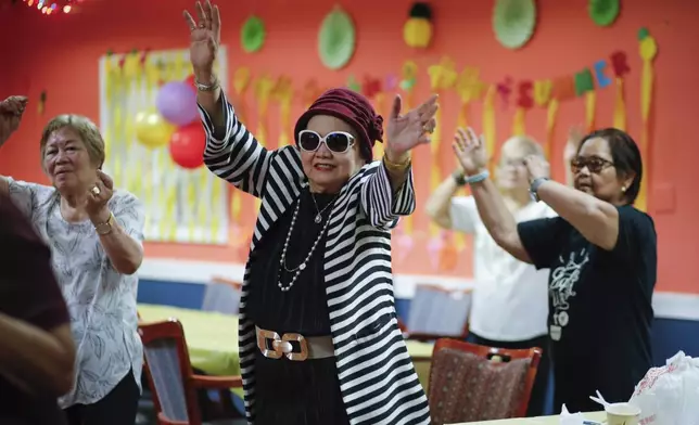 People attend a Zumba exercise class at Sunshine Adult Day Center in Bergenfield, N.J., Monday, Aug. 26, 2024. (AP Photo/Kena Betancur)