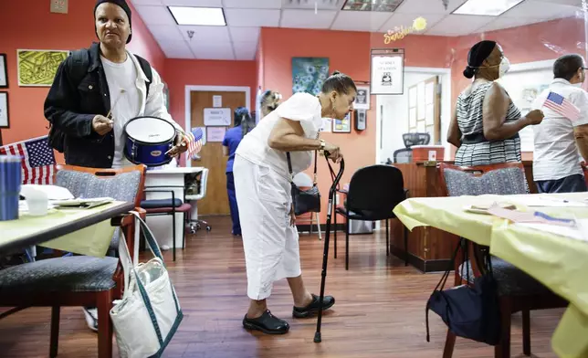 People take part in a multicultural parade inside Sunshine Adult Day Center in Bergenfield, N.J., Monday, Aug. 26, 2024. (AP Photo/Kena Betancur)