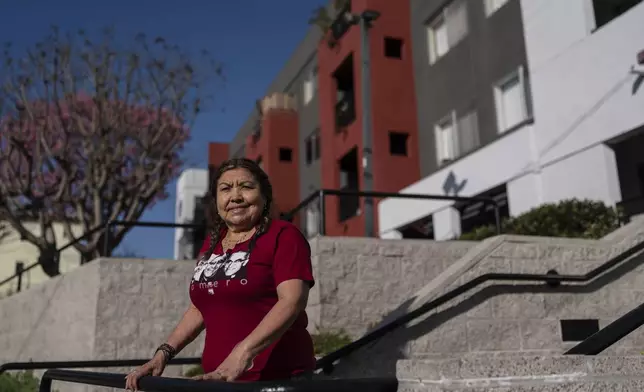 Marina Maalouf, a longtime resident of Hillside Villa who participated in protests after rents doubled in 2019, stands for a photo outside her apartment building in Los Angeles on Wednesday, Sept. 18, 2024. (AP Photo/Jae C. Hong)