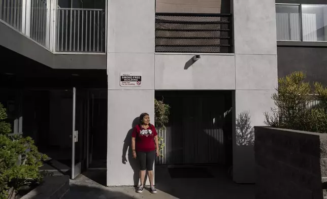 Marina Maalouf, a longtime resident of Hillside Villa who participated in protests after rents doubled in 2019, stands for a photo inside her apartment building in Los Angeles on Wednesday, Sept. 18, 2024. (AP Photo/Jae C. Hong)