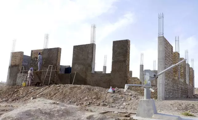 Afghan workers work to rebuild a house in Zinda Jan district, of Herat province, in western Afghanistan, Saturday, Sept. 28, 2024 following a 6.3 magnitude earthquake on Oct. 7, 2023. (AP Photo/Omid Haqjoo)