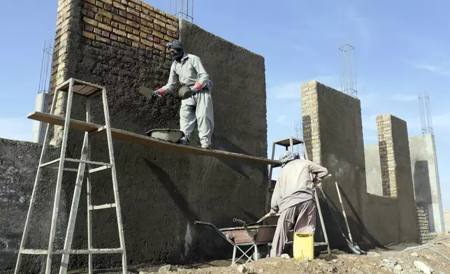 Afghan workers work to rebuild the house for survivors in Zinda Jan district, of Herat province, in western Afghanistan, Saturday, Sept. 28, 2024 after it was destroyed by a 6.3 magnitude earthquake on Oct. 7, 2023. (AP Photo/Omid Haqjoo)