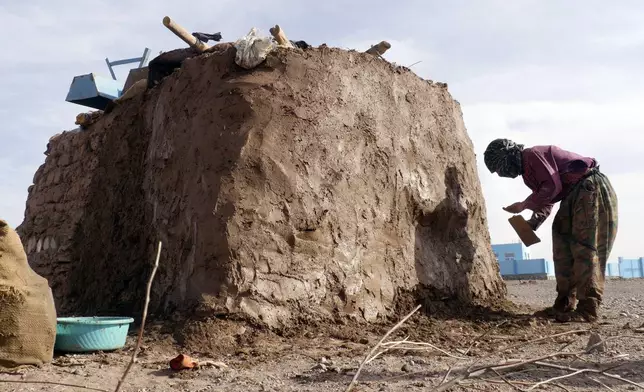 Survivor, makes a mud home in Zinda Jan district, of Herat province, in western Afghanistan, Saturday, Sept. 28, 2024 following a 6.3 magnitude earthquake on Oct. 7, 2023. (AP Photo/Omid Haqjoo)