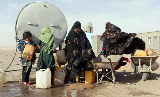 Survivors gather around a water tanker to get potable in Zinda Jan district, of Herat province, in western Afghanistan, Saturday, Sept. 28, 2024 following a 6.3 magnitude earthquake on Oct. 7, 2023. (AP Photo/Omid Haqjoo)