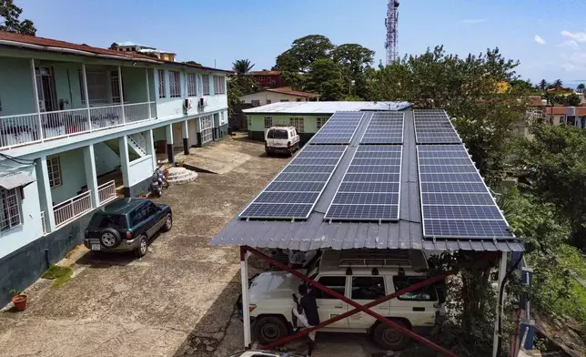 This photo released by Easy Solar shows a large solar panels installation on a rooftop of an office building in Freetown, Sierra Leone, Tuesday Aug. 13, 2024. (Muctarr Bah Mohamed/Easy Solar via AP)