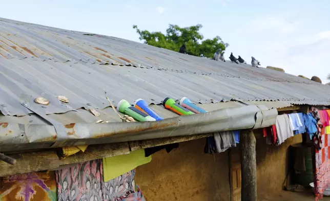 Solar torch lights are seen on the rooftop of a building in Gushegu northern, Ghana, Friday Sept. 6, 2024. (AP Photos/Abdul Haqq Mahama)