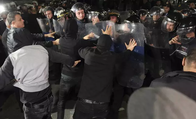 Albanian opposition protesters scuffle with riot police during a blockage of a main avenue demanding that the government be replaced by a technocratic caretaker Cabinet, in Tirana, Albania, Tuesday, Oct. 29, 2024. (AP Photo/Vlasov Sulaj)