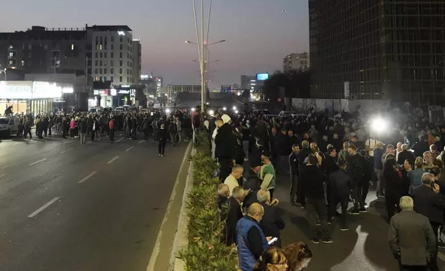 Albanian opposition protesters block a main avenue demanding that the government be replaced by a technocratic caretaker Cabinet, in Tirana, Albania, Tuesday, Oct. 29, 2024. (AP Photo/Vlasov Sulaj)