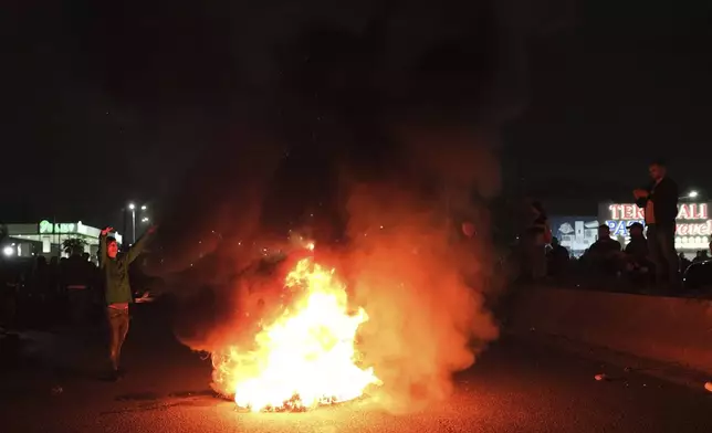 Albanian opposition protesters burn tyres during a blockage of a main avenue demanding that the government be replaced by a technocratic caretaker Cabinet, in Tirana, Albania, Tuesday, Oct. 29, 2024. (AP Photo/Vlasov Sulaj)