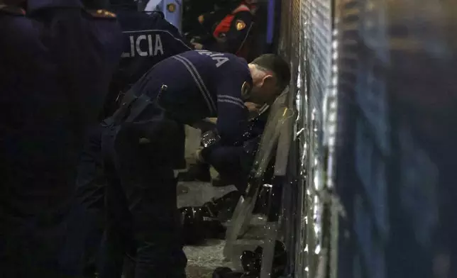 An Albania police man washes his face during an anti-government rally set up by the opposition, in Tirana, Albania, Monday, Oct. 7, 2024. (AP Photo/Hameraldi Agolli)