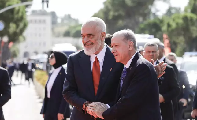 Prime Minister of Albania Edi Rama, left, welcomes Turkey's President Recep Tayyip Erdogan before their meeting in Tirana, Albania, Thursday, Oct. 10, 2024. (AP Photo/Hameraldi Agolli)