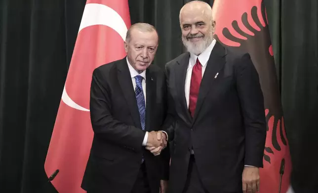 Prime Minister of Albania Edi Rama, right, shakes hands with Turkey's President Recep Tayyip Erdogan during a join news conference after they sing bilateral agreements in Tirana, Albania, Thursday, Oct. 10, 2024. (AP Photo/Vlasov Sulaj)