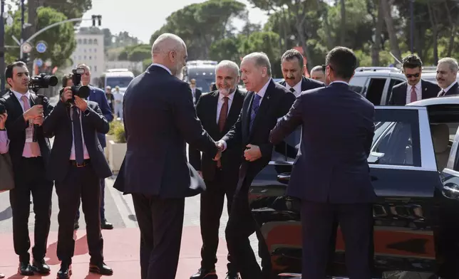 Prime Minister of Albania Edi Rama, left, welcomes Turkey's President Recep Tayyip Erdogan before their meeting in Tirana, Albania, Thursday, Oct. 10, 2024. (AP Photo/Hameraldi Agolli)