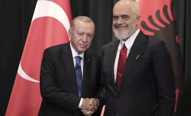 Prime Minister of Albania Edi Rama, right, shakes hands with Turkey's President Recep Tayyip Erdogan during a join news conference after they sing bilateral agreements in Tirana, Albania, Thursday, Oct. 10, 2024. (AP Photo/Vlasov Sulaj)