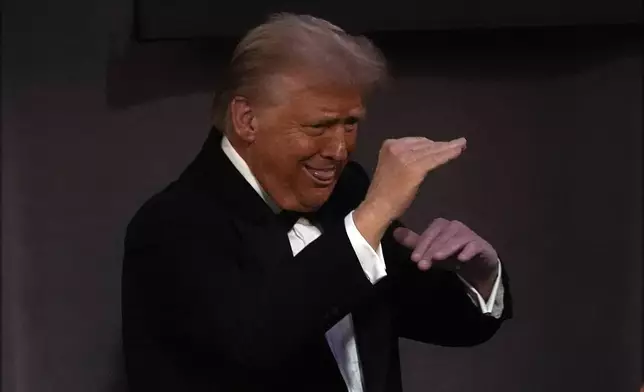 Republican presidential nominee former President Donald Trump gestures as he departs the 79th annual Alfred E. Smith Memorial Foundation Dinner, Thursday, Oct. 17, 2024, in New York. (AP Photo/Julia Demaree Nikhinson)