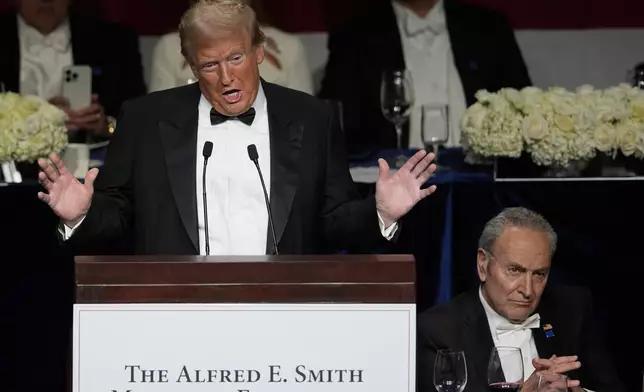 Republican presidential nominee former President Donald Trump speaks as Senate Majority Leader Chuck Schumer of N.Y., listens at the 79th annual Alfred E. Smith Memorial Foundation Dinner, Thursday, Oct. 17, 2024, in New York. (AP Photo/Julia Demaree Nikhinson)