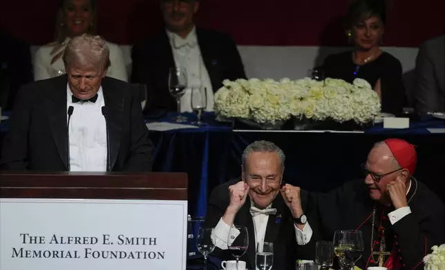 Republican presidential nominee former President Donald Trump speaks at the 79th annual Alfred E. Smith Memorial Foundation Dinner, Thursday, Oct. 17, 2024, in New York, as Senate Majority Leader Chuck Schumer of N.Y., and Cardinal Timothy Dolan listen. (AP Photo/Julia Demaree Nikhinson)