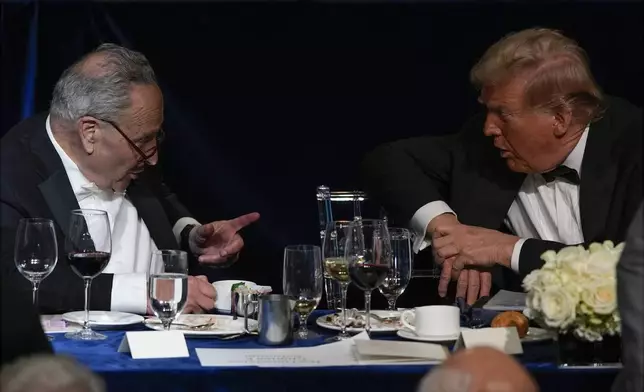 Republican presidential nominee former President Donald Trump talks with Senate Majority Leader Chuck Schumer of N.Y., at the 79th annual Alfred E. Smith Memorial Foundation Dinner, Thursday, Oct. 17, 2024, in New York. (AP Photo/Julia Demaree Nikhinson)