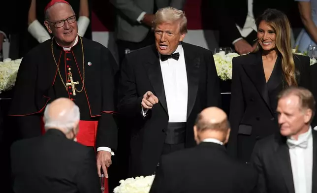 Republican presidential nominee former President Donald Trump and former first lady Melania Trump arrive for the 79th annual Alfred E. Smith Memorial Foundation Dinner, Thursday, Oct. 17, 2024, in New York. (AP Photo/Julia Demaree Nikhinson)