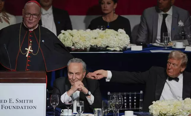 Senate Majority Leader Chuck Schumer of N.Y., listens as Cardinal Timothy Dolan shakes hands with Republican presidential nominee former President Donald Trump at the 79th annual Alfred E. Smith Memorial Foundation Dinner, Thursday, Oct. 17, 2024, in New York. (AP Photo/Julia Demaree Nikhinson)