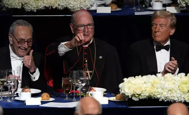 Senate Majority Leader Chuck Schumer of N.Y., and Cardinal Timothy Dolan gesture as Republican presidential nominee former President Donald Trump watches at the 79th annual Alfred E. Smith Memorial Foundation Dinner, Thursday, Oct. 17, 2024, in New York. (AP Photo/Julia Demaree Nikhinson)