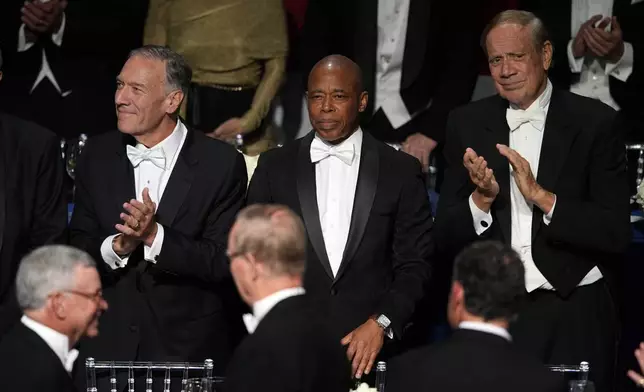 New York City Mayor Eric Adams, center, and former Secretary of State Mike Pompeo, left, arrive for the 79th annual Alfred E. Smith Memorial Foundation Dinner, Thursday, Oct. 17, 2024, in New York. (AP Photo/Julia Demaree Nikhinson)