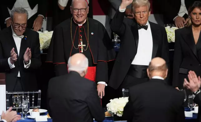 Republican presidential nominee former President Donald Trump and former first lady Melania Trump, along with Cardinal Timothy Dolan and Senate Majority Leader Chuck Schumer of N.Y., left, arrive for the 79th annual Alfred E. Smith Memorial Foundation Dinner, Thursday, Oct. 17, 2024, in New York. (AP Photo/Julia Demaree Nikhinson)