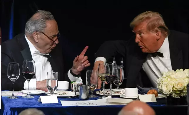 Republican presidential nominee former President Donald Trump atalks with Senate Majority Leader Chuck Schumer of N.Y., at the 79th annual Alfred E. Smith Memorial Foundation Dinner, Thursday, Oct. 17, 2024, in New York. (AP Photo/Julia Demaree Nikhinson)